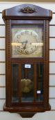 Stained wood wall clock, with arched pediment, the brass dial with geometric spandrels, moulding