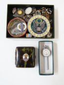 Collection of assorted badges, buckles, brooches etc., a cigarette case, and an inches to miles