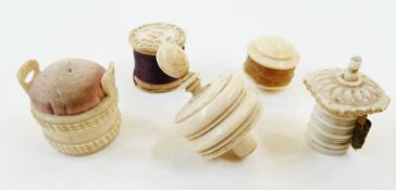 Carved bone bucket pattern pin cushion, two carved bone tape measures, bone waxer and British