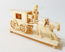 Carved ivory horsedrawn carriage, with driver (some parts missing), 11cm long