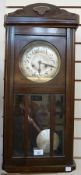 Twentieth century stained oak wall clock, with shaped pediment, striking movement