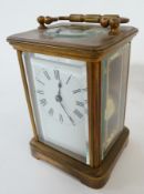 Brass carriage clock, with striking movement, in plain case with triple bar handle, on bracket feet,