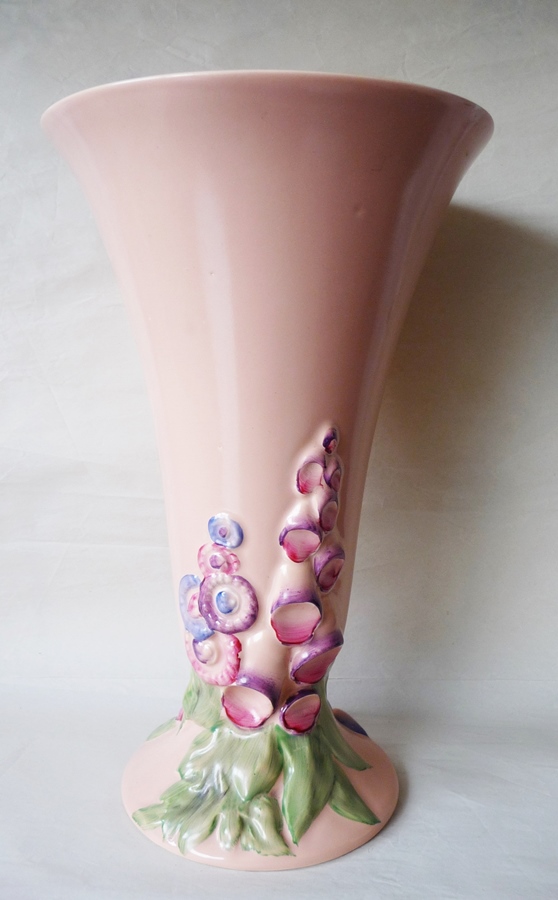 A Clarice Cliff trumpet-shaped vase, decorated foxgloves on a pink ground