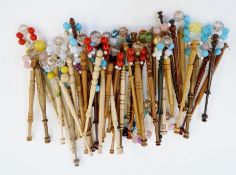 Approximately thirty eight lace bobbins, with beaded decoration