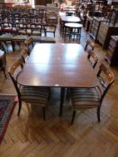 A nineteenth century mahogany drop flap dining table on square tapering legs with casters, length