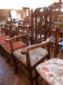 Four early twentieth century oak dining chairs and oak open arm carver's chair, in the Arts and