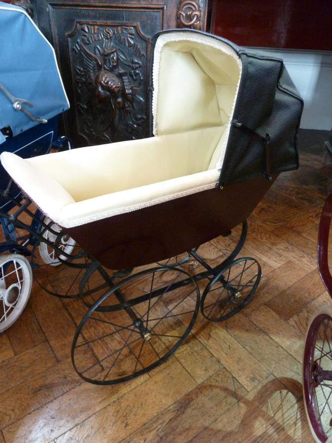 Edwardian restored doll's pram, with cream leather interior and black leatherette folding hood