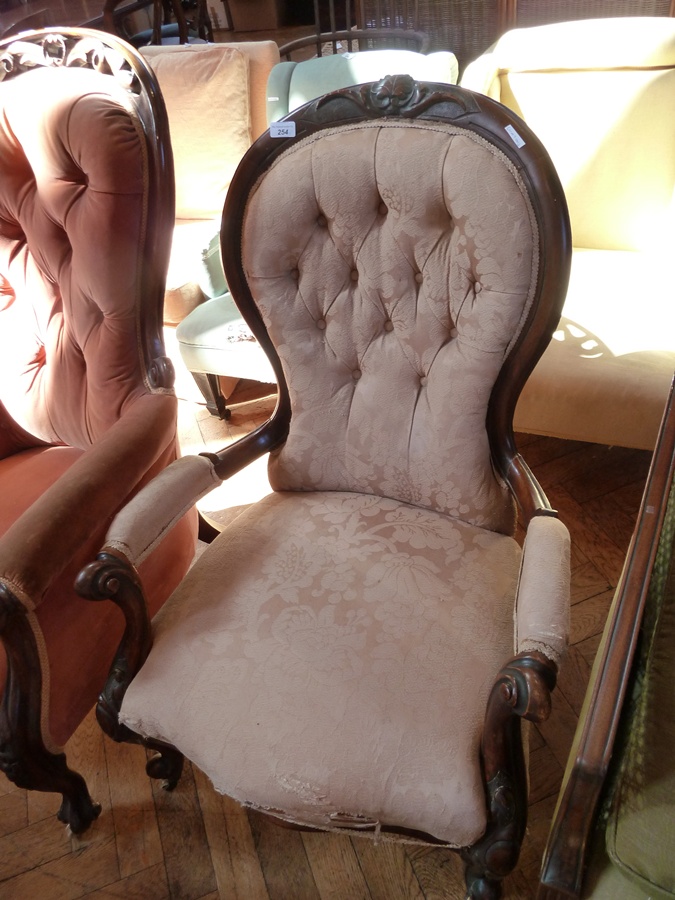 Victorian walnut open arm drawing room chair, the waisted button back with carved toprail, carved