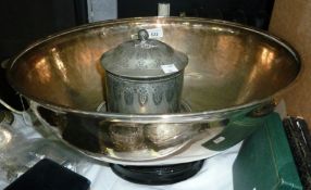 A large silver plate meat cover converted into a bowl on a wooden stand together with a silver plate