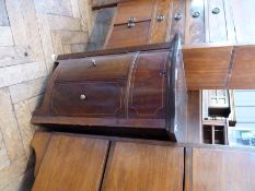 An old mahogany gramophone cabinet with rising top, and bow front cupboard below, raised on
