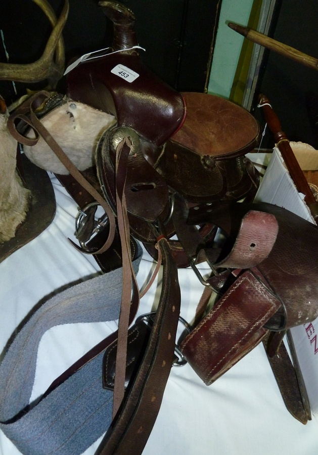 A leather saddle with silver coloured mounts with fur lining