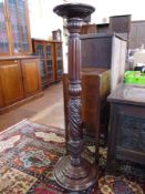 A Victorian mahogany jardiniere stand, with heavily reeded and foliate carved support to a stepped