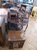 A nest of three oak occasional tables, an Edwardian oval occasional table with wavy edge top and