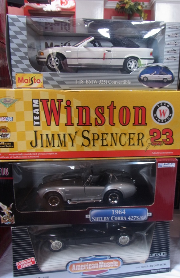 A 1/18 scale Maisto BMW 325i convertible, a Winston Jimmy Spencer, a 1964 Shelby Cobra and a 1969