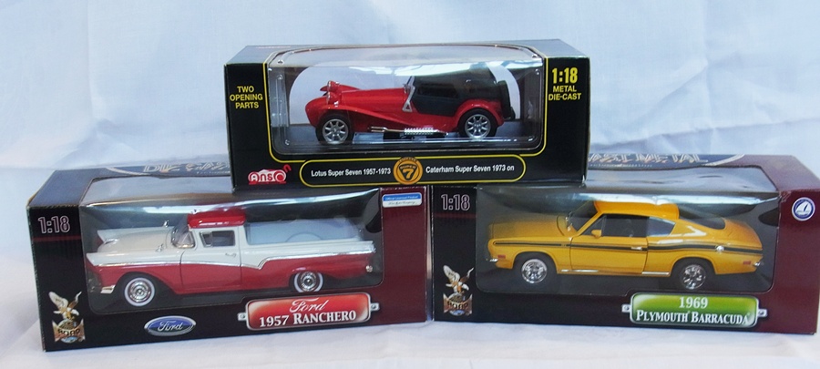 A 1/18 scale diecast model Ford 1957 Ranchero, a Caterham Super 7, 1973 and a 1969 Plymouth