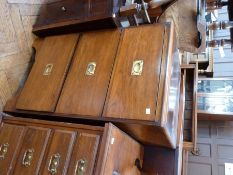 A walnut chest of three deep drawers, with flush brass handles, on bracket feet, width 57cms