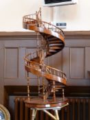 Apprentice piece model of a spiral staircase, with turned spindle supports, raised on a circular