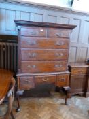 A Georgian mahogany chest on stand, with dentil cornice, two short and three long graduated drawers,