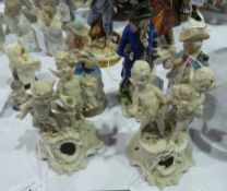 Two Parianware groups of cherubs holding wreaths and pouring wine, and three other porcelain figures