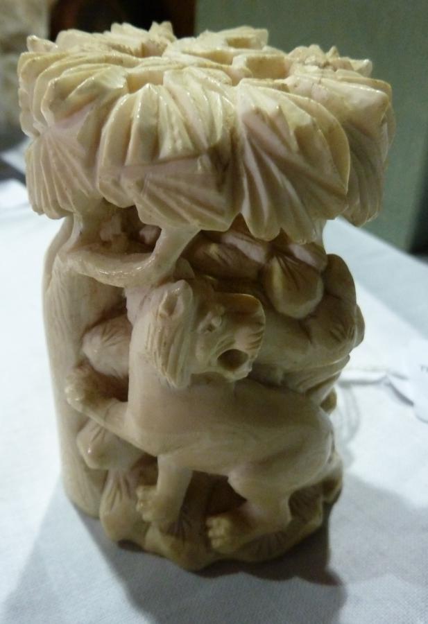 Ivory model, cylindrical carving of lion and eastern figure on horse beside tree, 6.5 cm high