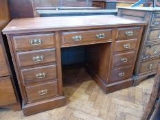 An Edwardian walnut pedestal desk, with three frieze drawers and three further short drawers to