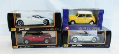 A 1/16 scale diecast model of a Mini Cooper, a 1/18 scale Maistro Mini Cooper, Ford GT90 and a