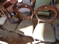 Three Victorian mahogany dining chairs, each with hoop back, on turned supports