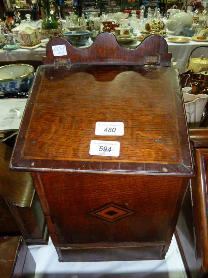 Antique oak knife box, with a shaped raised back, cross-banding and lozenge inlaid with single