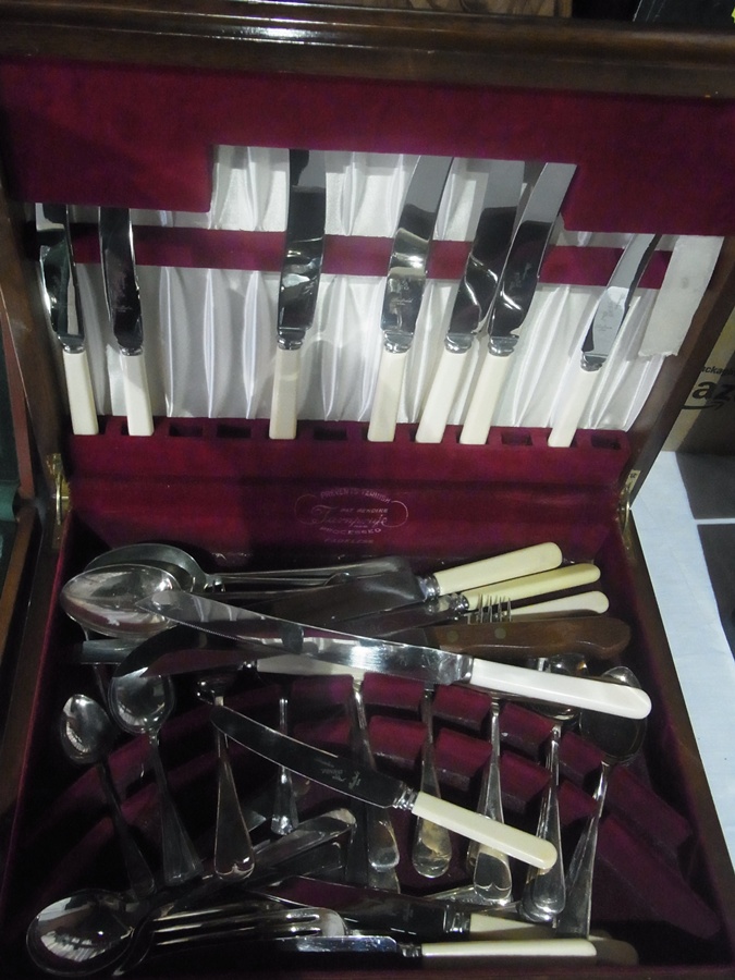 A six piece part canteen of stainless steel cutlery, with ivory handles in a fitted burr walnut