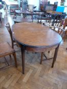 A twentieth century oak extending dining table, on turned tapering legs, length 144cms