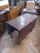 A George III mahogany drop flap dining table with shaped frieze on square chamfered legs, width