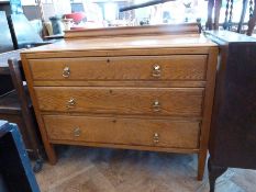 A pale oak chest of three long graduated drawers raised on square tapering legs, width 99cms,