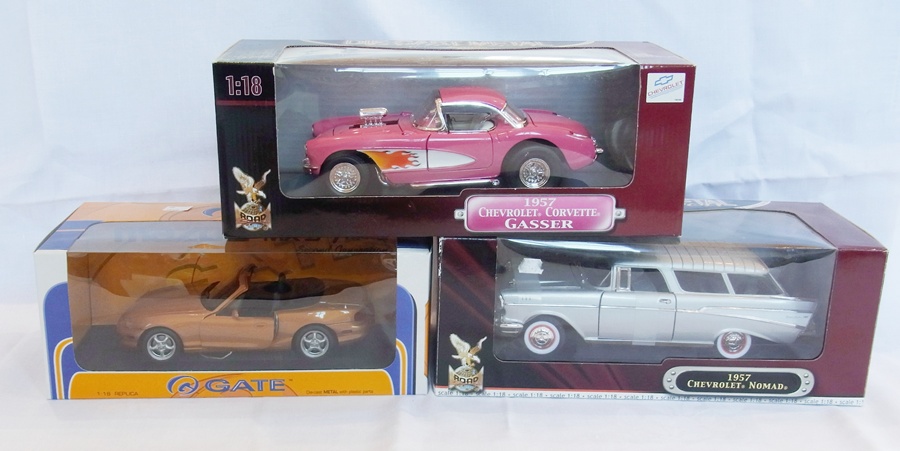 A 1/18 scale diecast metal model of a Madza MX5, a 1957 Chevrolet Nomad and a 1957 Chevrolet