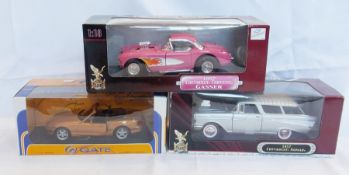 A 1/18 scale diecast metal model of a Madza MX5, a 1957 Chevrolet Nomad and a 1957 Chevrolet