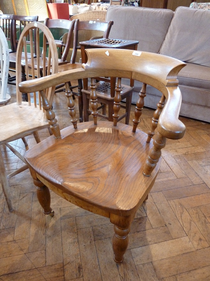 Oak smoker's bow open armchair, with curved shoulderboard to the toprail, baluster turned