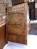A Victorian mahogany clothes cupboard, the pair of arched panelled doors central doors enclosing
