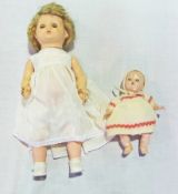 Palitoy walking vinyl doll, with blonde wig, and a small BND 1930s/40s hard plastic baby doll (2)