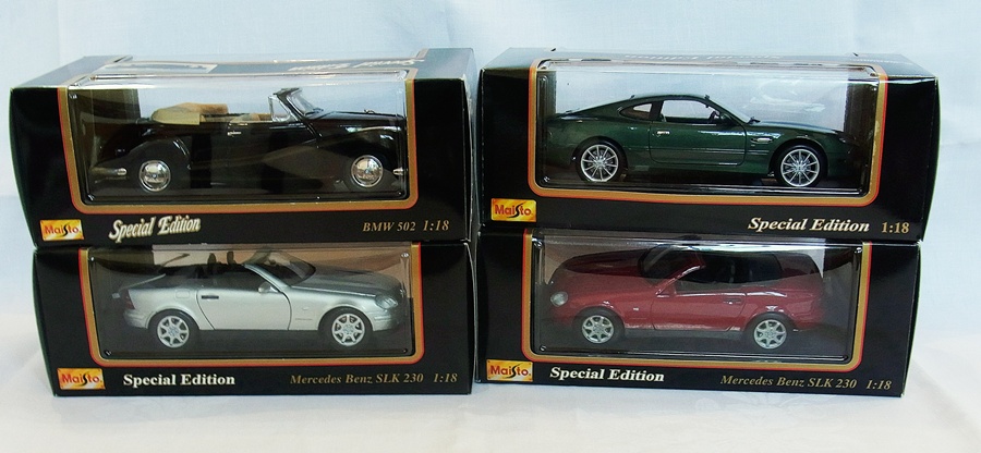 A 1/18 scale Maisto Mercedes Benz SLK 230, a Mercedes Benz SLK 230, a BMW 502 and an Aston Martin