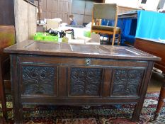 A seventeenth century panelled oak coffer, the three panel top with original staple hinges and