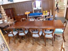 Georgian style mahogany twin pedestal dining table, with reeded edge, on turned column supports with