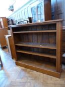 A late Victorian oak open bookcase of three shelves raised on a plinth base, width 120cms