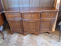 A reproduction mahogany Georgian style breakfront sideboard, with three drawers, with three panelled