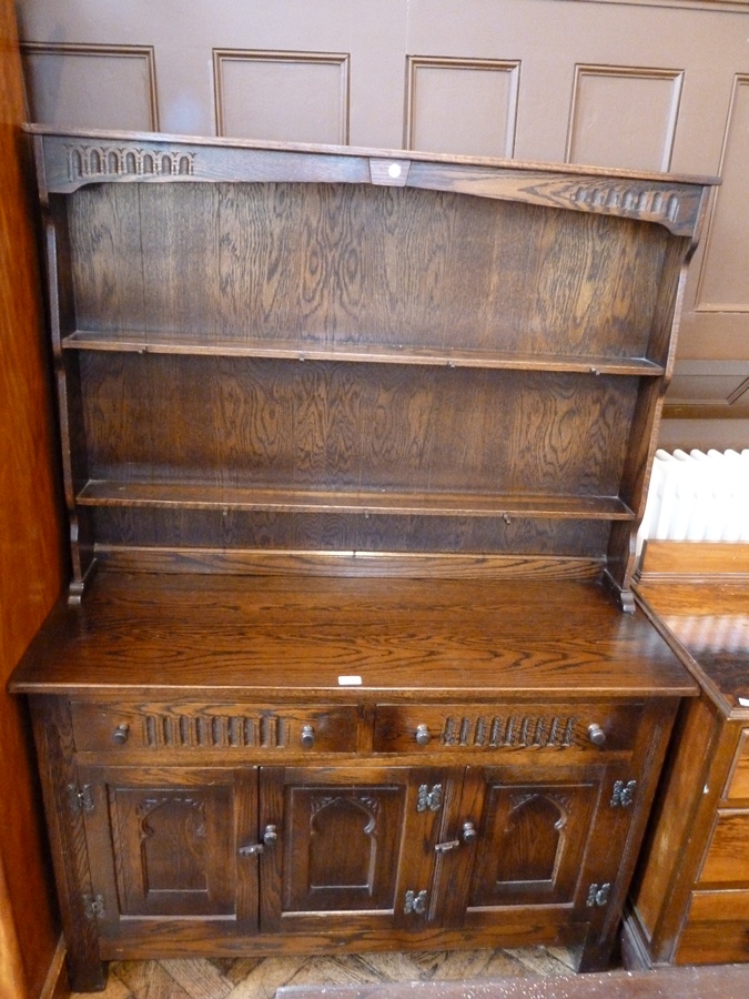 20th century oak dresser with two shelves and pegs above two drawers and cupboards below, on