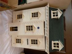 A reproduction Georgian style dolls house, with hinged front and box of household contents with