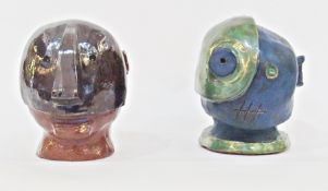 Two contemporary ceramic sculptures, in the form of human heads, both approximately 20 cm high