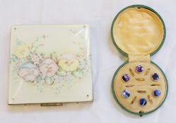 A square compact decorated with pansies, gold coloured and purple dress studs in a circular box (2)