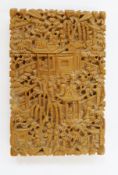 A Chinese carved boxwood card case, showing immortals in temples amongst foliage