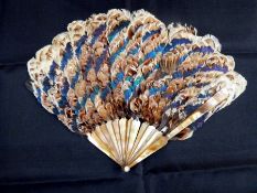 Late Victorian/Edwardian mother-of-pearl and feather fan, game bird feathers including:-