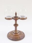 Victorian turned wood and glass double lacemakers lamp, having two glass bulbous lamps, the wooden