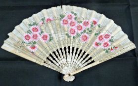 Bone and paper fan, the pierced sticks gilt decorated, the printed leaf decorated with